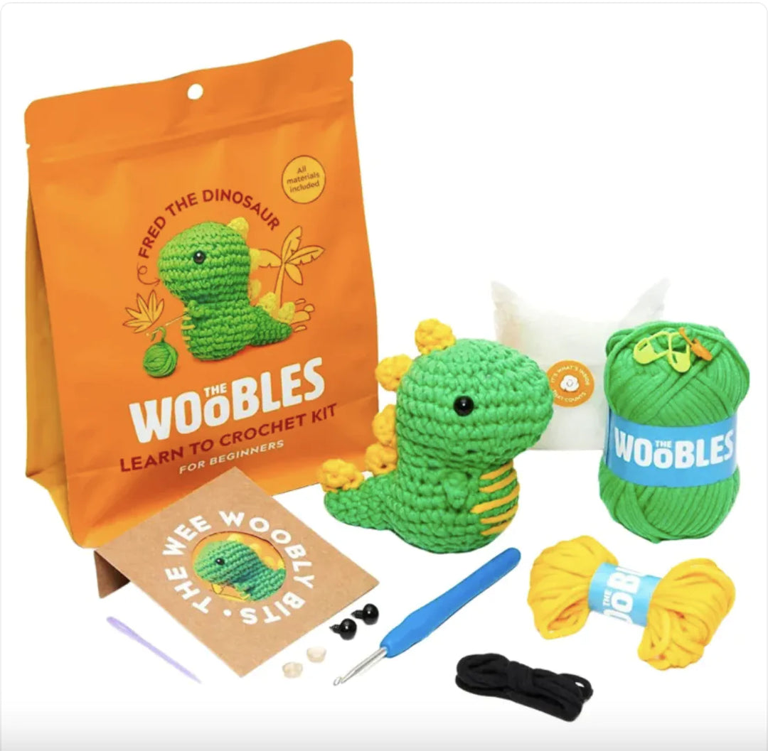 Beginner crochet kit with yarn, tools, and dinosaur design