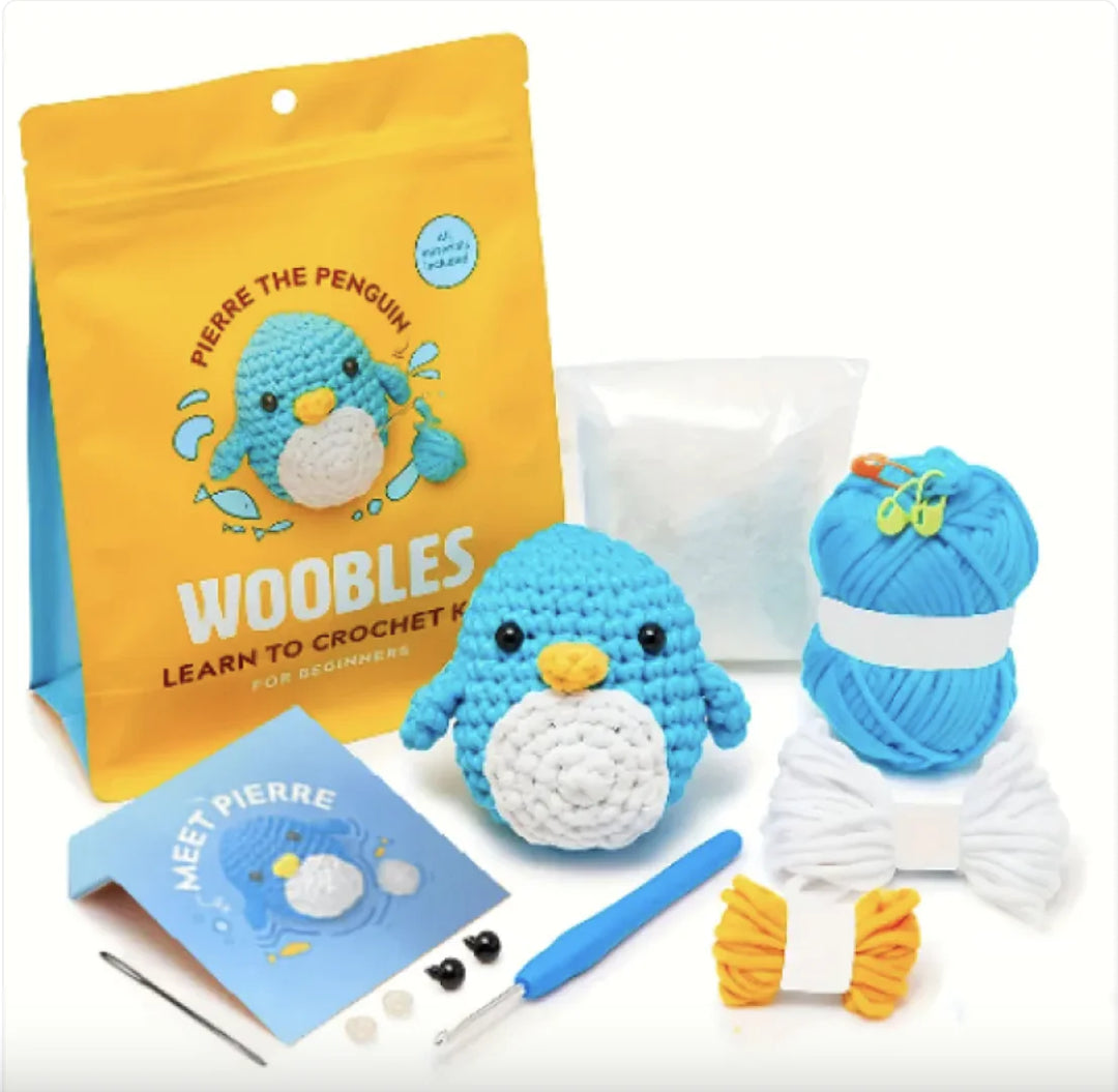 Beginner crochet kit with yarn, tools, and penguin design