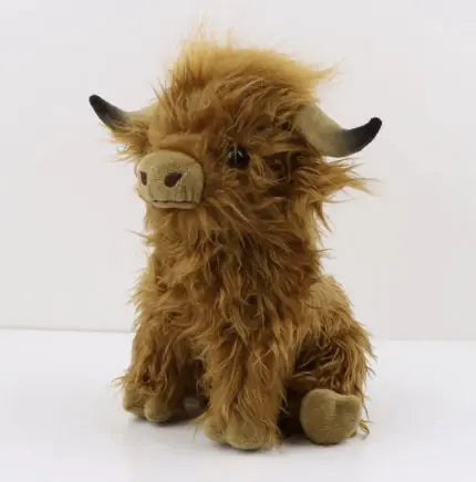 Fluffy Scottish Highland cow plush toy with long brown fur and black horns